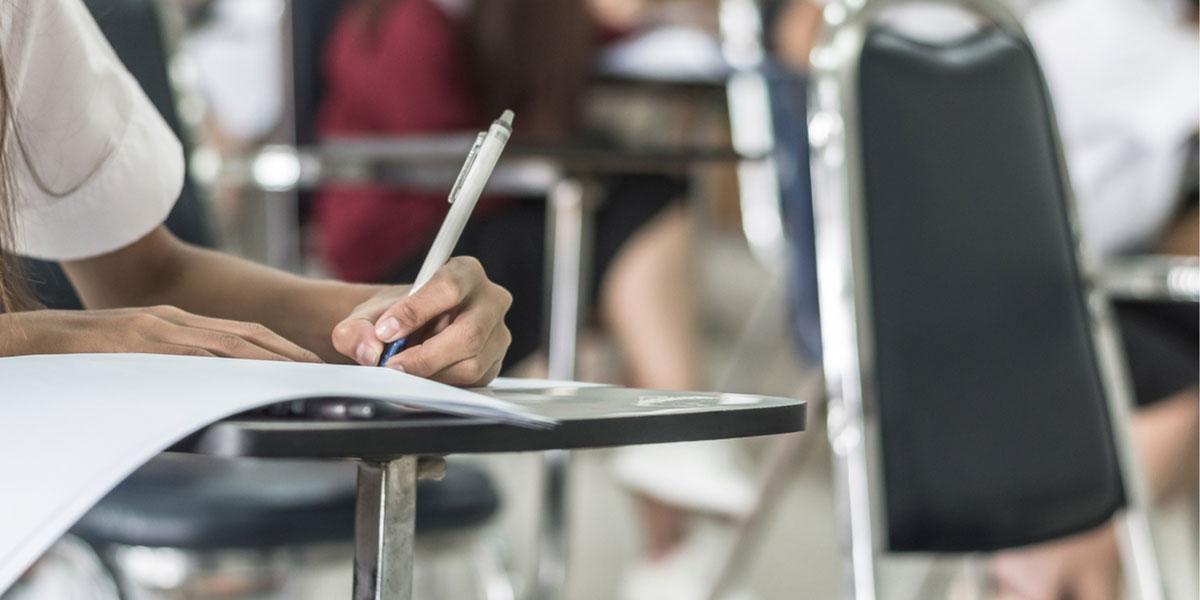 Student writes at her desk.